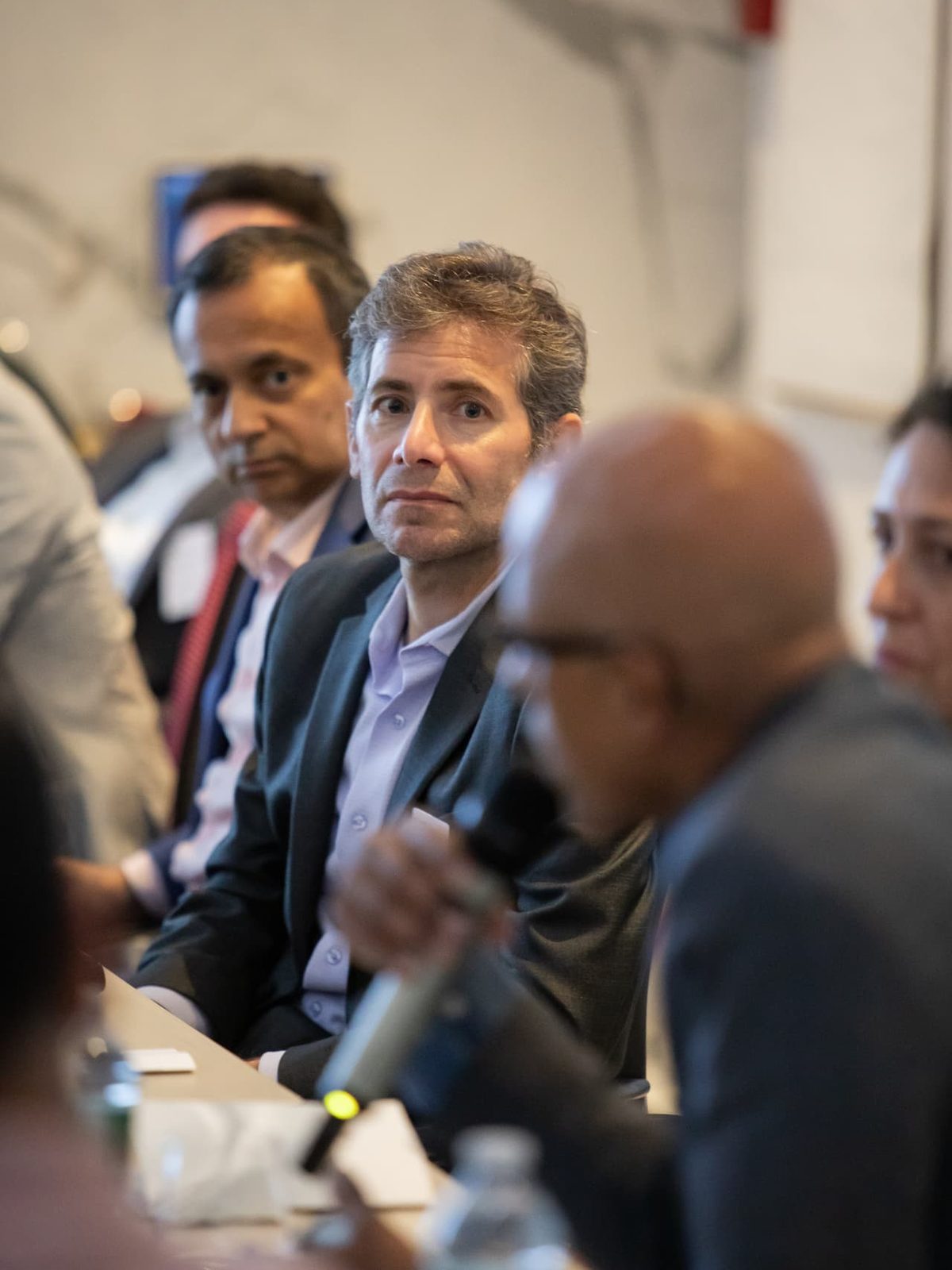 An executive listening intently at the table during an EDC Evening Roundtable working session.