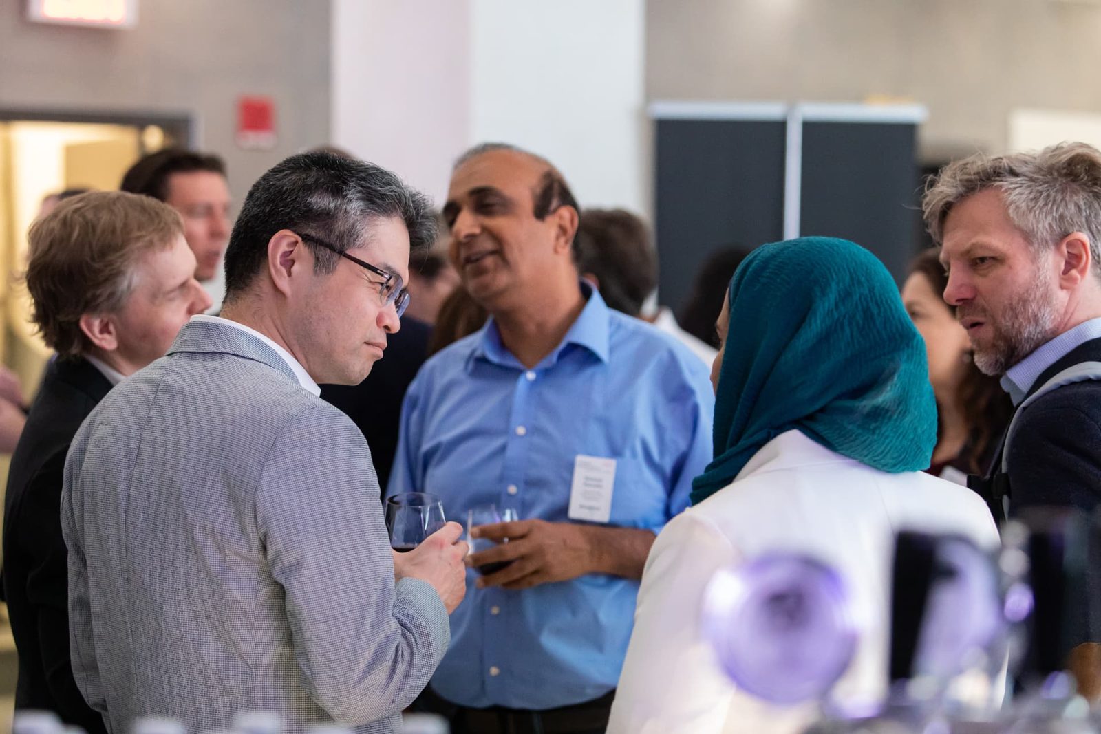 A mixed group of four executives in discussion at an EDC Evening Roundtable reception.